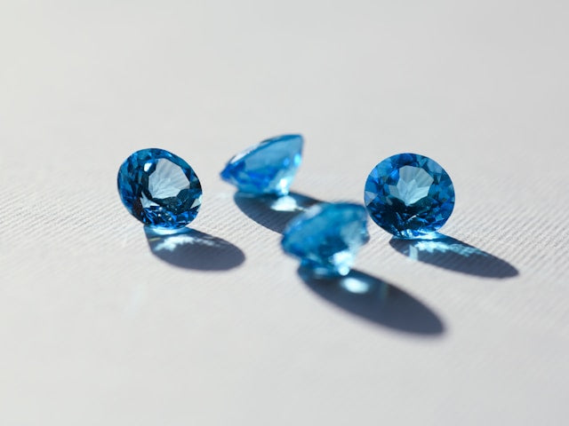 Faceted blue topaz gemstones with vivid reflections and high clarity